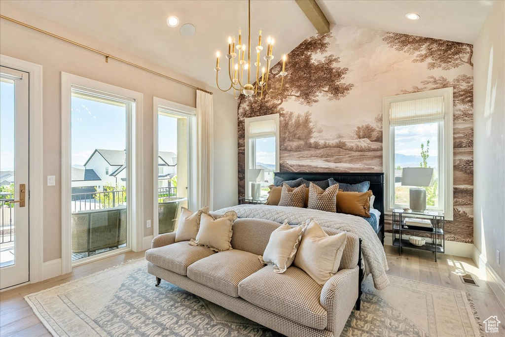 Bedroom with access to outside, wood finished floors, a chandelier, baseboards, and wallpapered walls