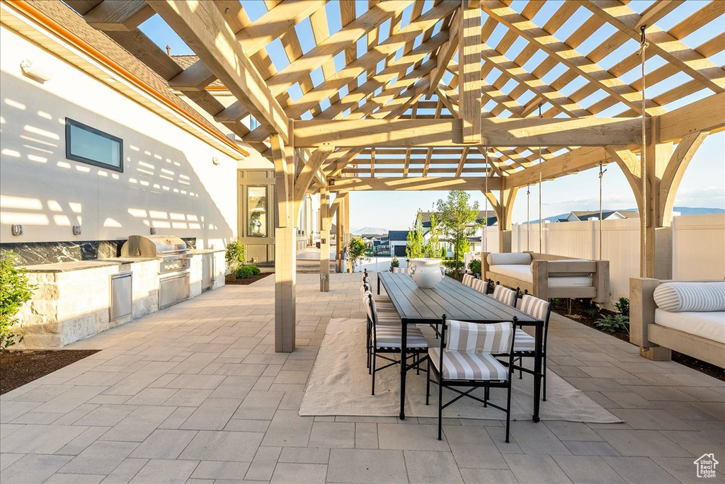 View of patio / terrace featuring a pergola and outdoor dining space