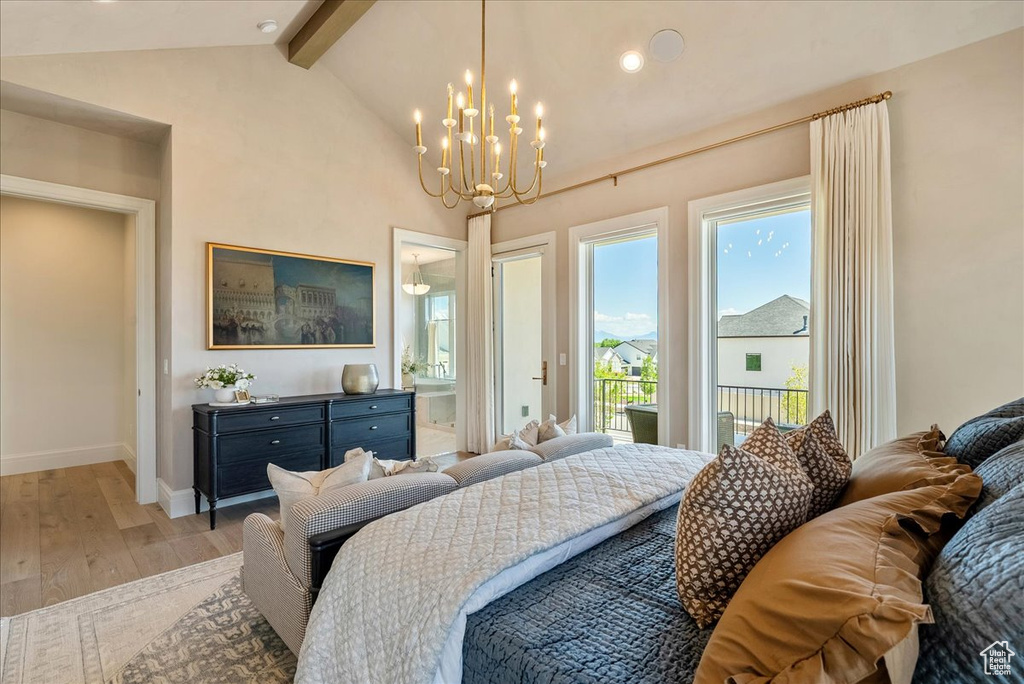 Bedroom featuring a chandelier, light wood finished floors, baseboards, access to outside, and ensuite bath