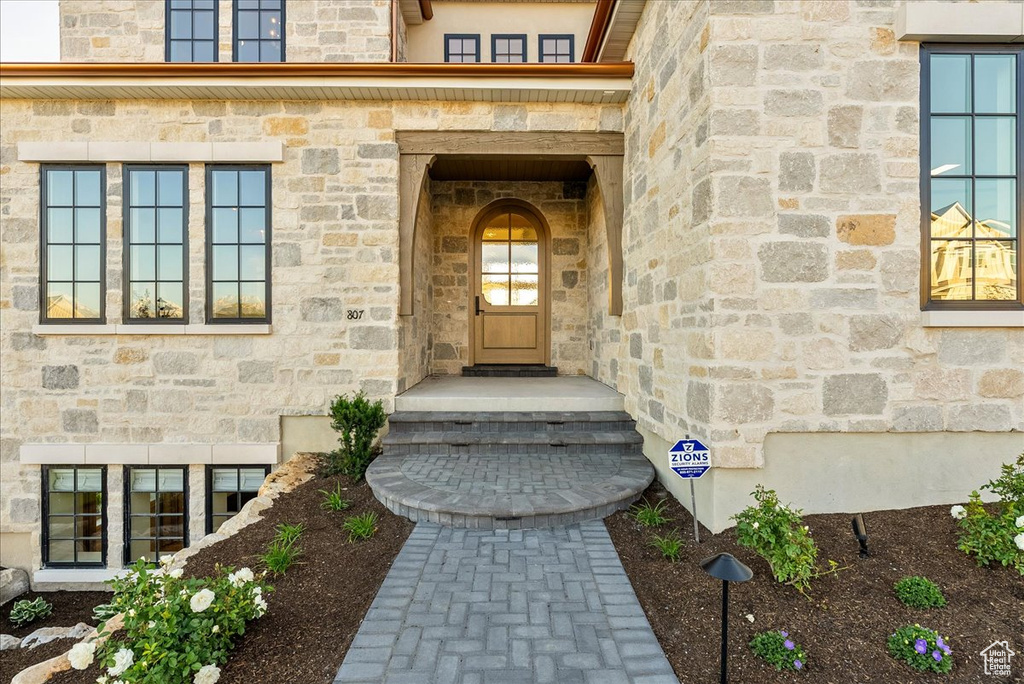 Doorway to property with stone siding