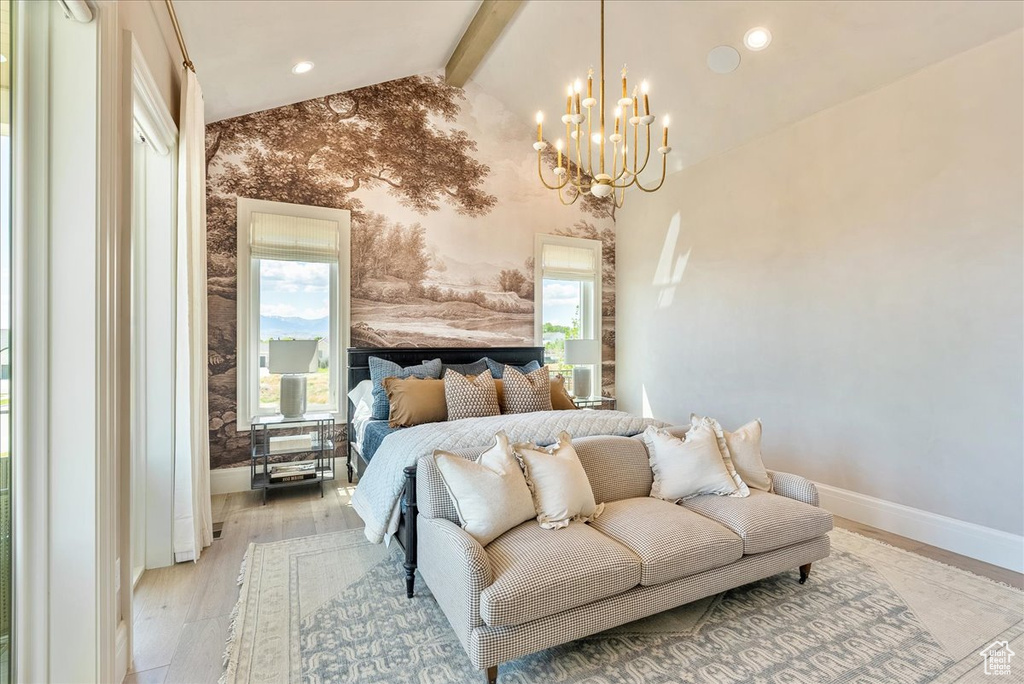 Bedroom featuring multiple windows, baseboards, a chandelier, wallpapered walls, and light wood finished floors