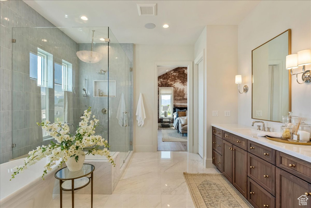 Full bathroom with vanity, a shower stall, plenty of natural light, marble tiled floors, and recessed lighting