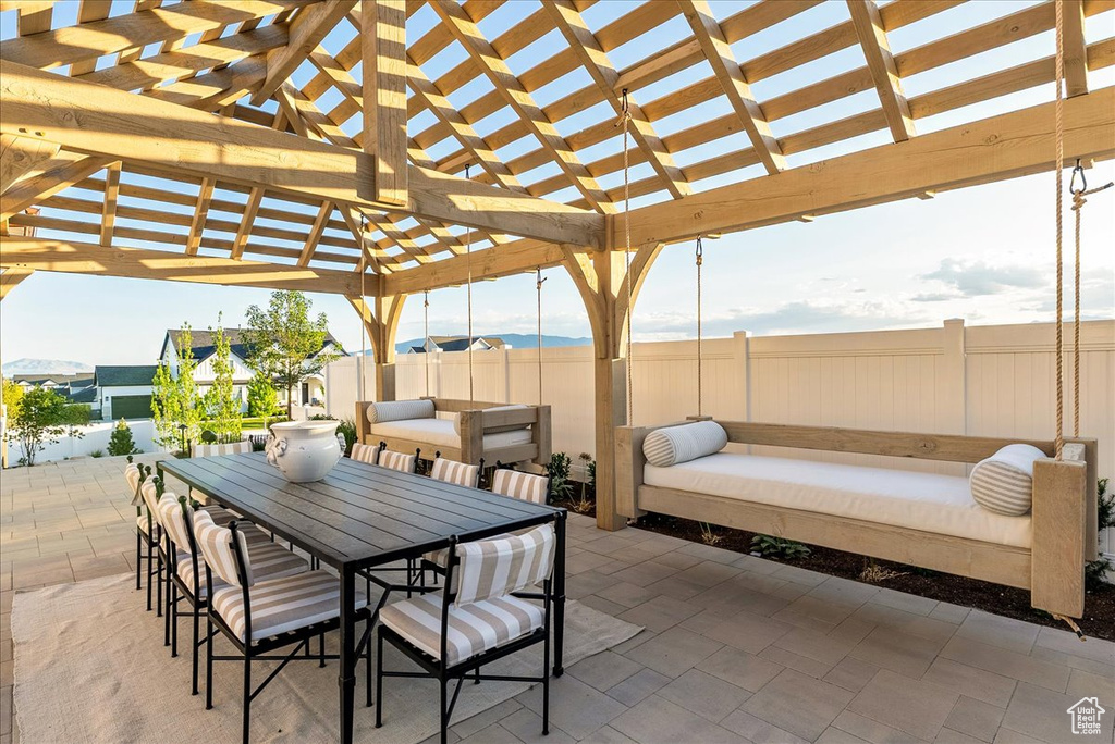 View of patio with a pergola and outdoor dining space