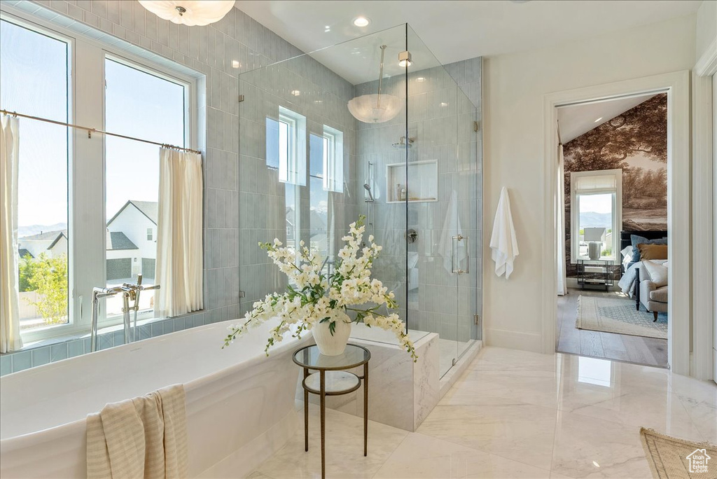 Bathroom with a stall shower and recessed lighting