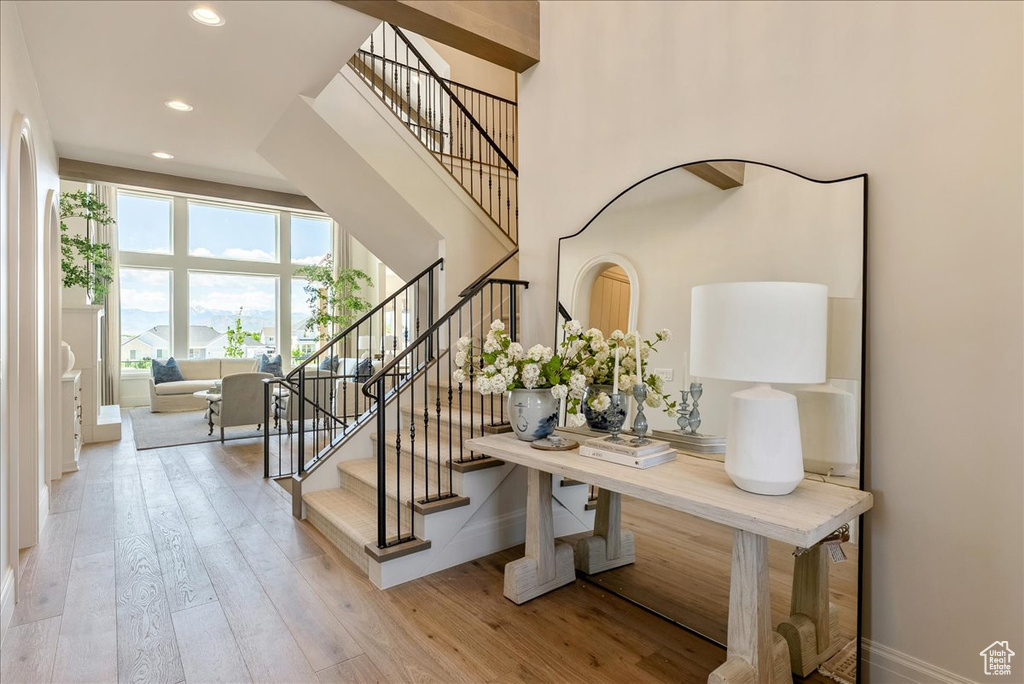 Staircase featuring wood finished floors, recessed lighting, and baseboards