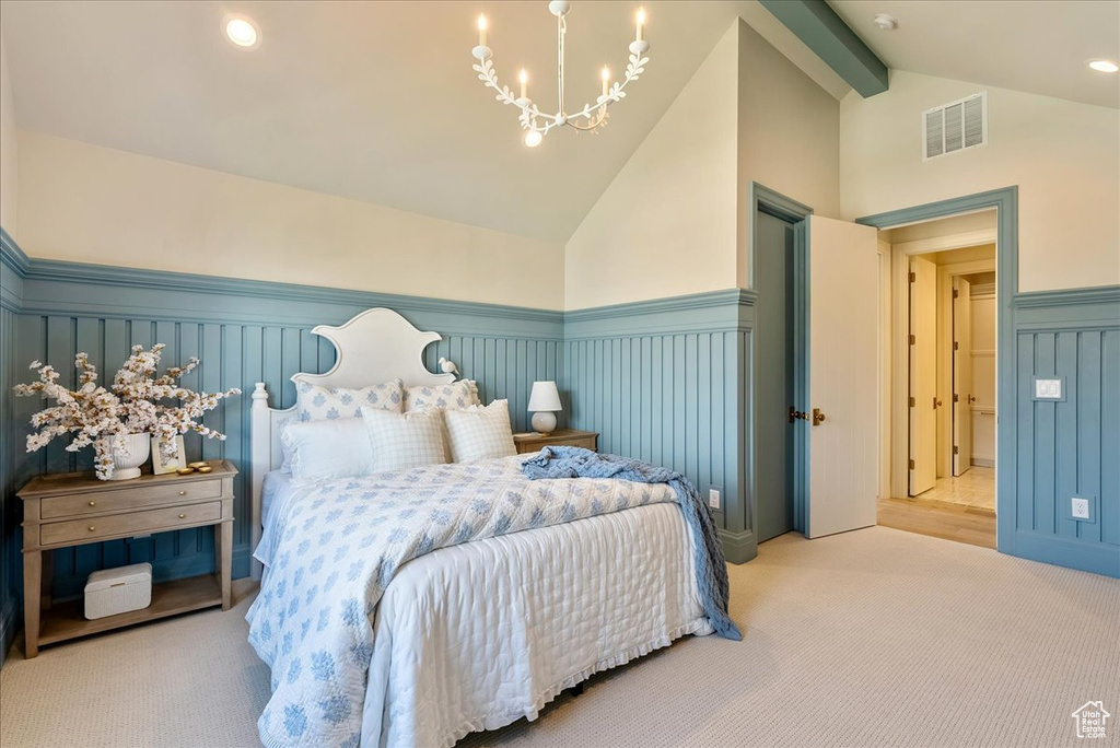 Bedroom with a wainscoted wall, carpet floors, a chandelier, and a decorative wall