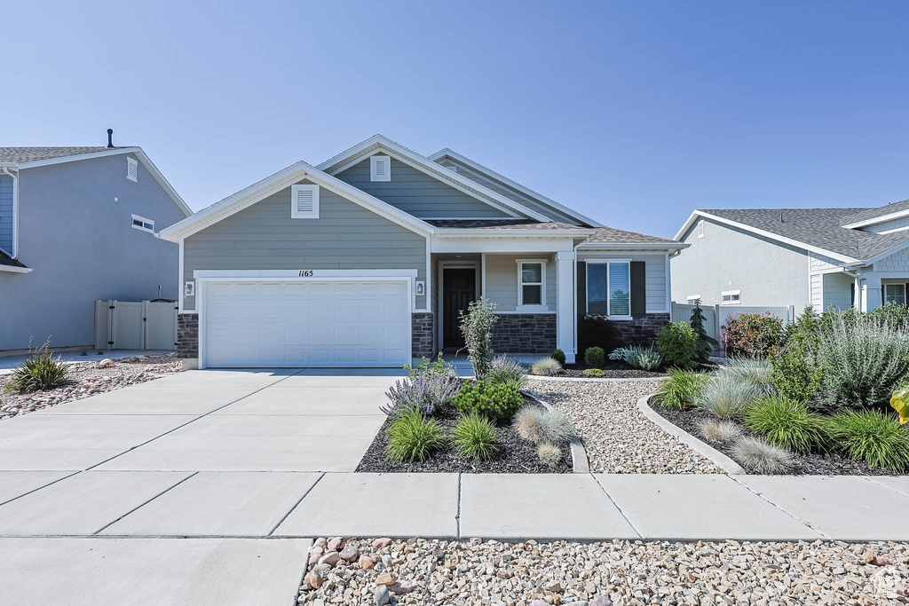 Craftsman house with an attached garage and concrete driveway