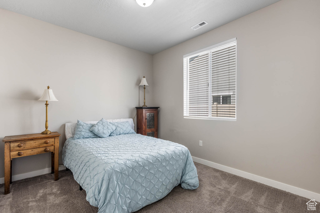 Carpeted bedroom featuring baseboards