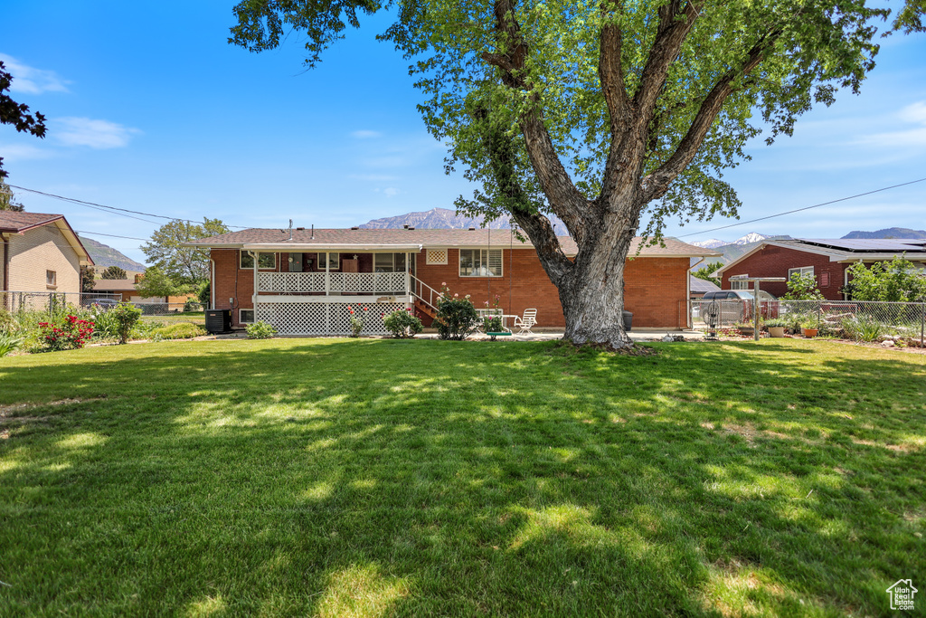 Rear view of house featuring brick siding and stairway