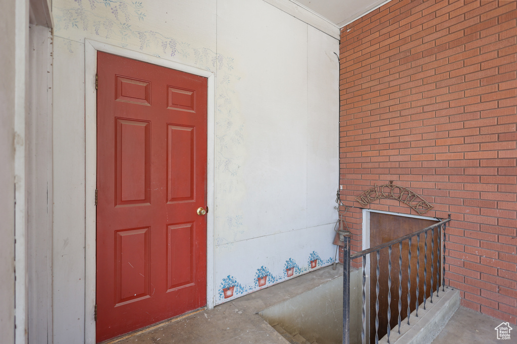 Doorway to property with brick siding