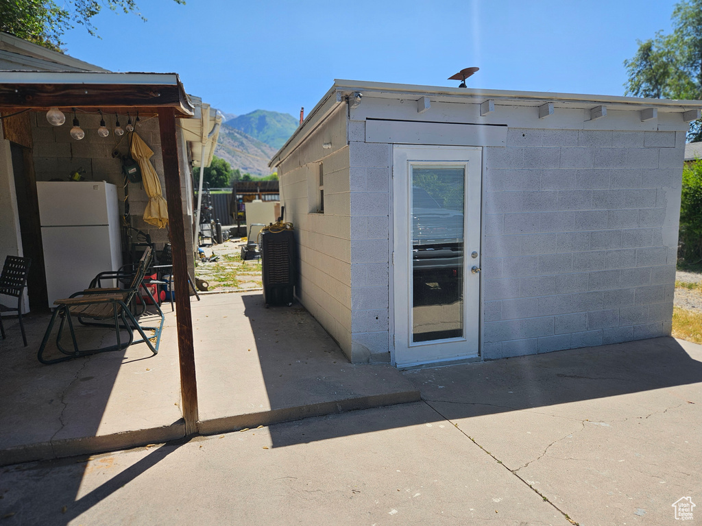View of patio with a mountain view and an outbuilding