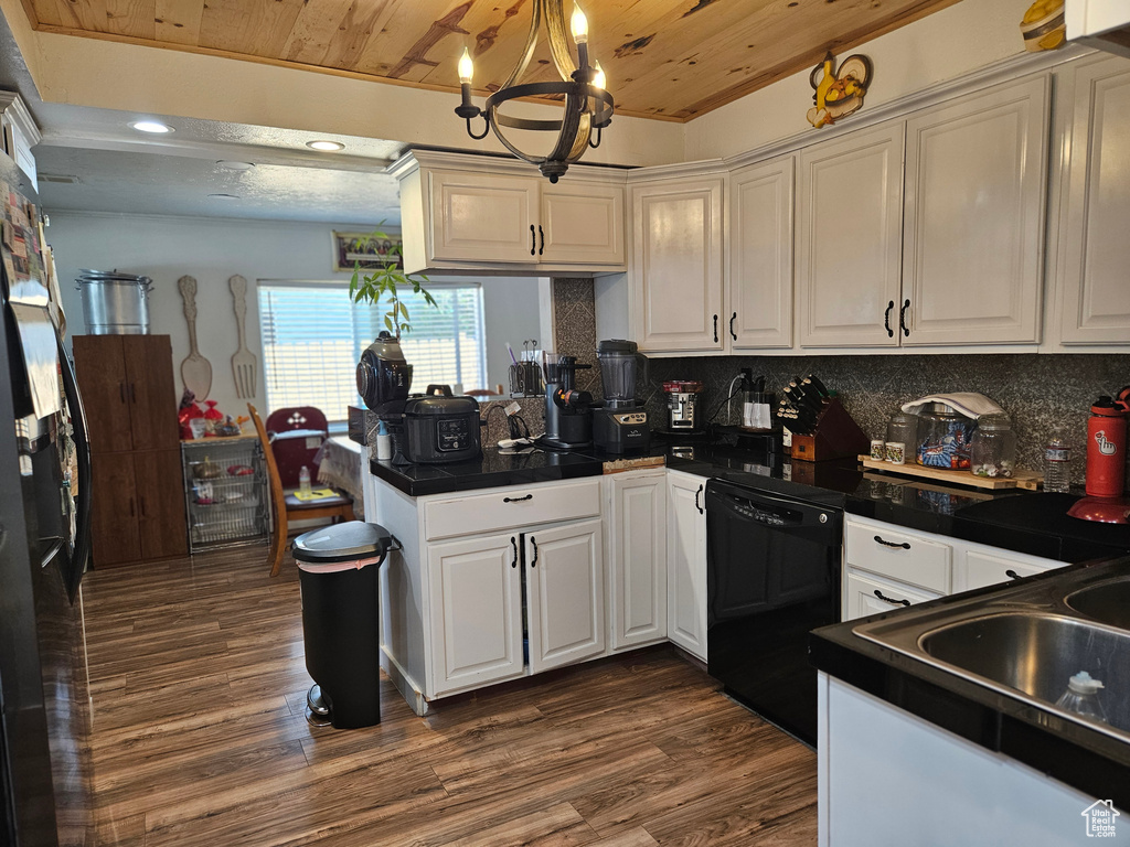 Kitchen with dishwasher, wood ceiling, dark countertops, a chandelier, and a peninsula