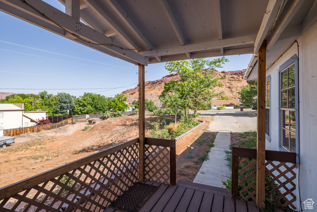 Wooden terrace with a mountain view and a patio area