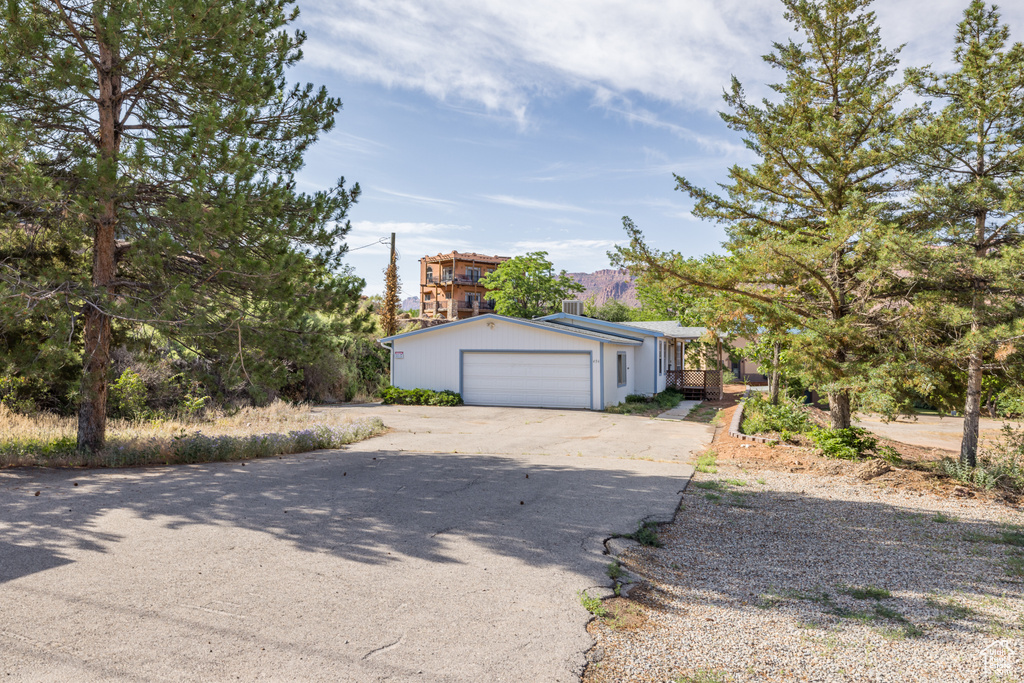 View of front facade featuring driveway and a garage