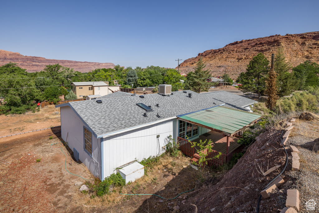 Aerial view of property and surrounding area featuring a mountain backdrop