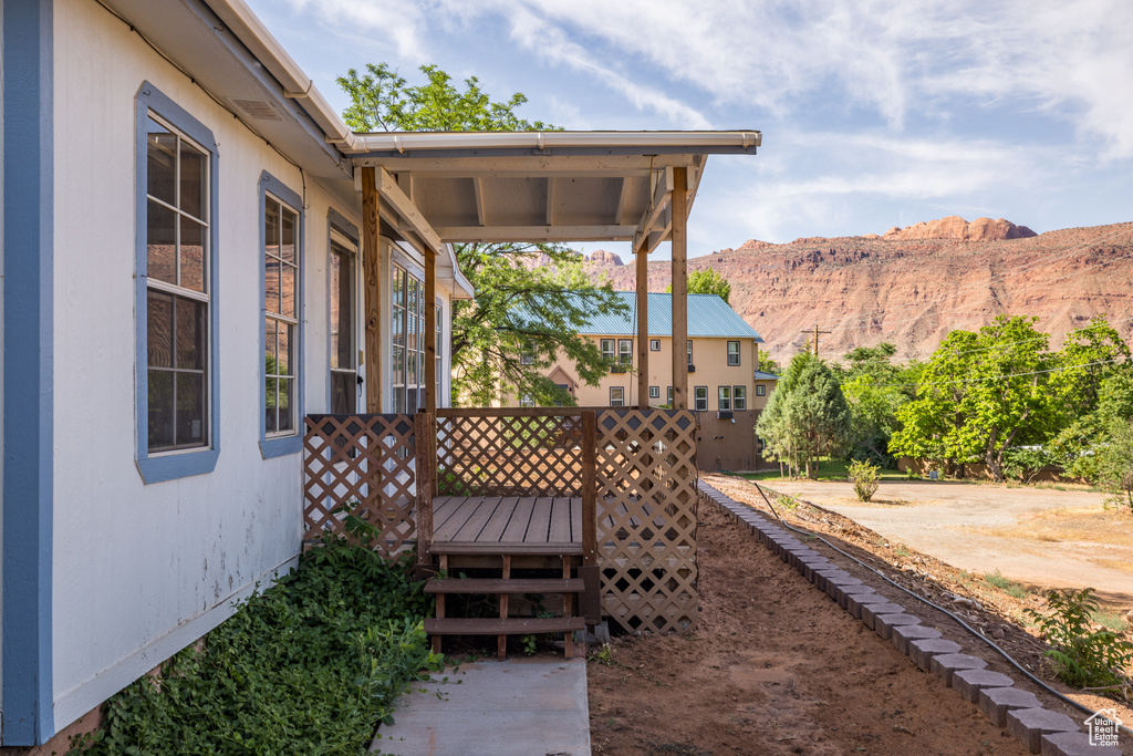 View of yard with a deck with mountain view
