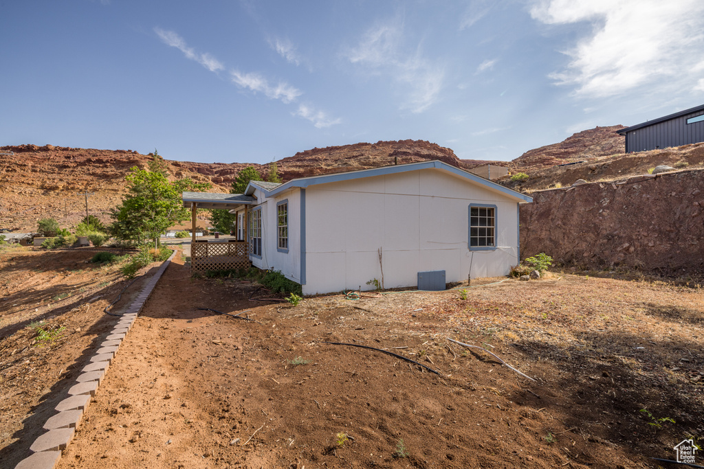 View of side of property with a mountain view