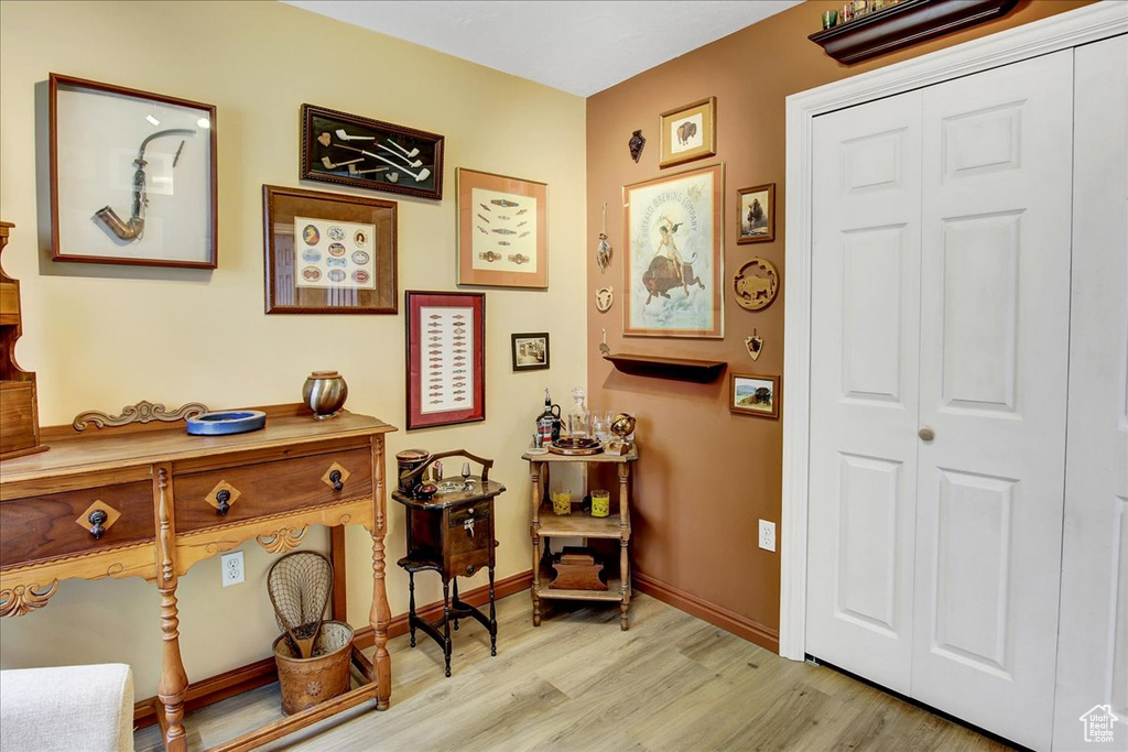 Living area with light wood-style flooring and baseboards