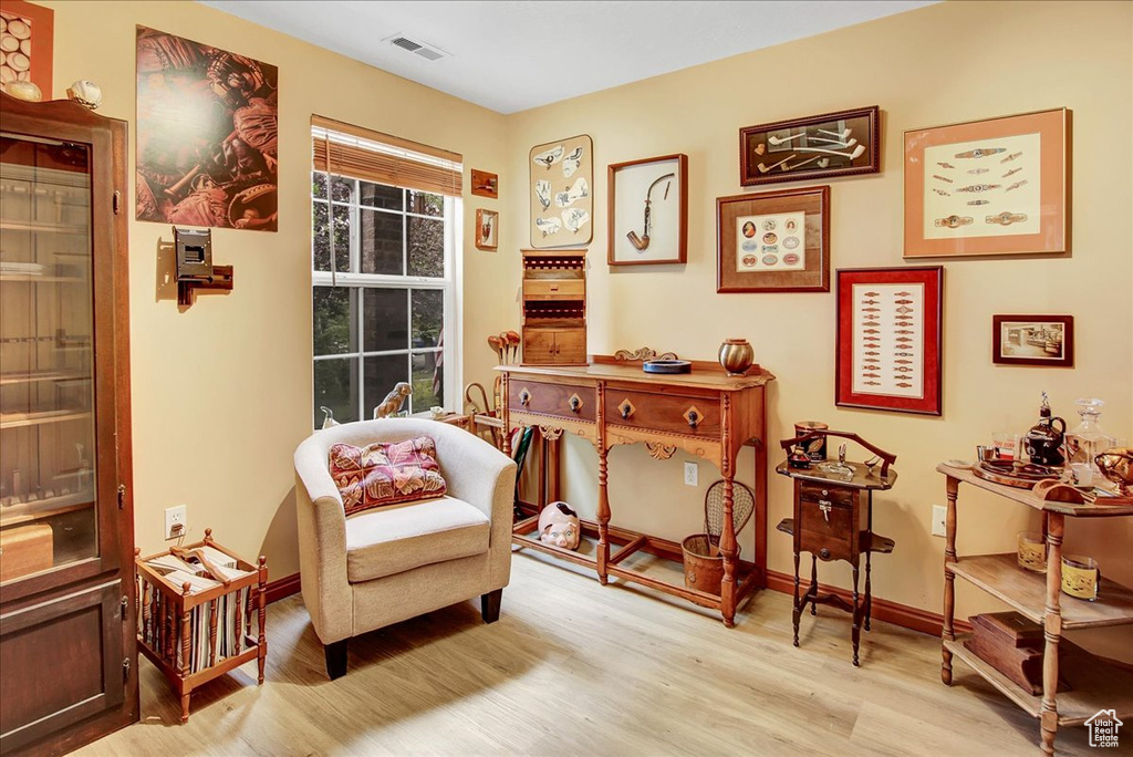 Living area featuring light wood-type flooring and baseboards
