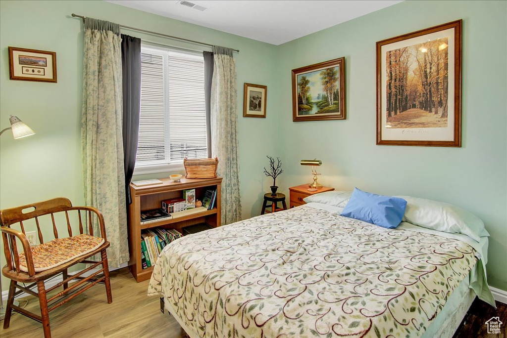 Bedroom featuring light wood-style floors and baseboards