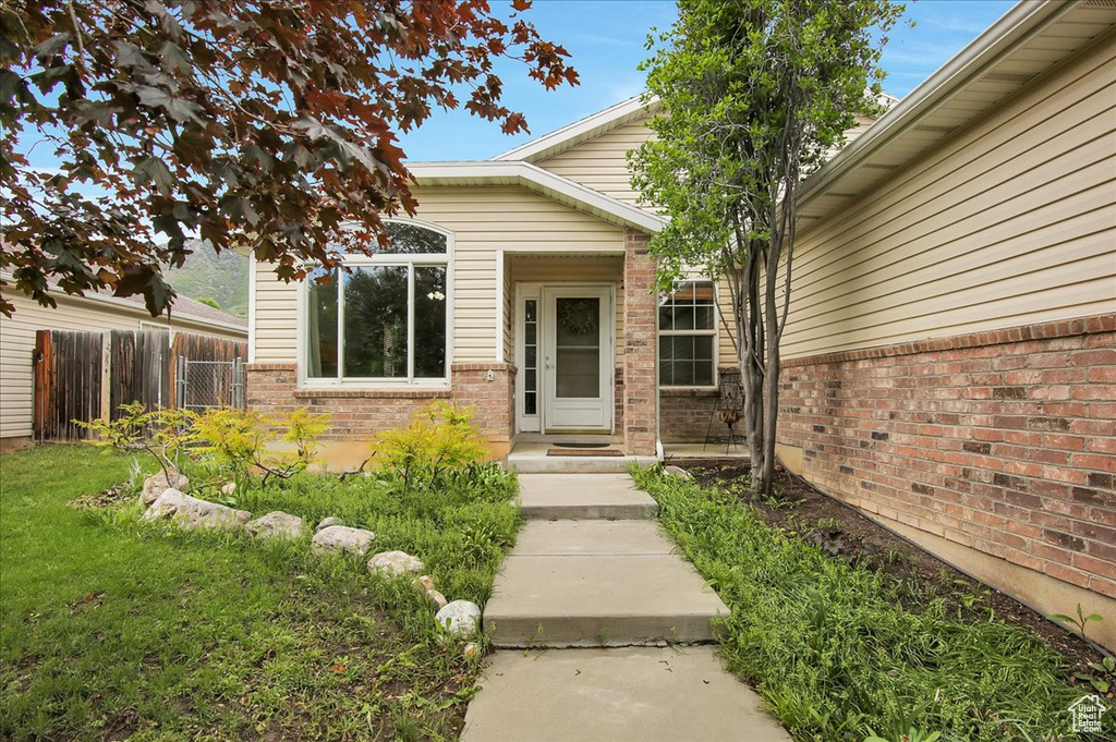 Entrance to property featuring brick siding