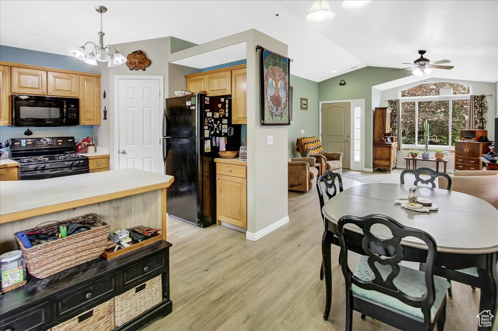 Kitchen featuring black appliances, vaulted ceiling, light countertops, light brown cabinetry, and ceiling fan