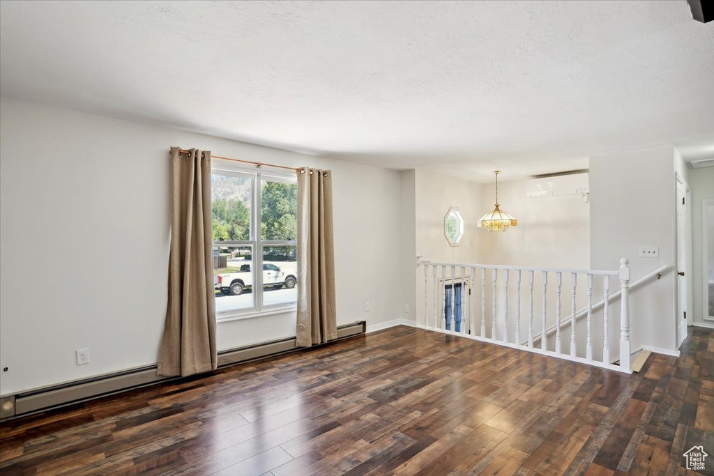 Spare room featuring wood finished floors and baseboards