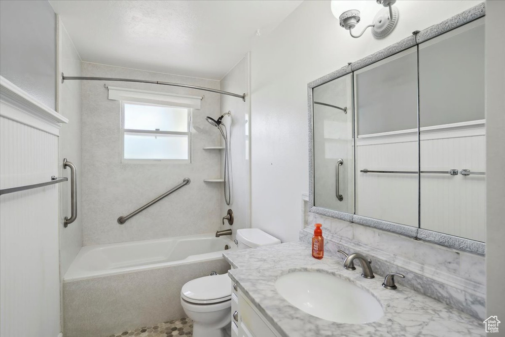 Full bathroom featuring toilet, shower / tub combination, vanity, and decorative backsplash