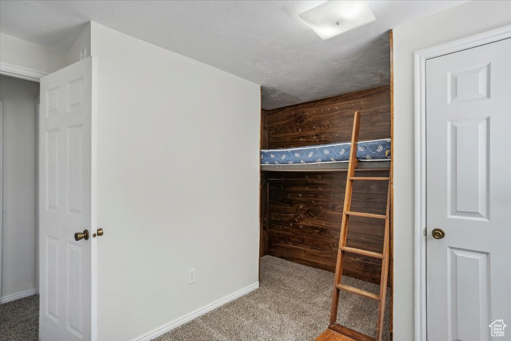 Unfurnished bedroom with carpet flooring and baseboards