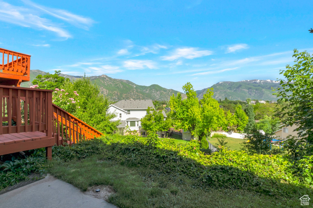 View of yard with a deck with mountain view