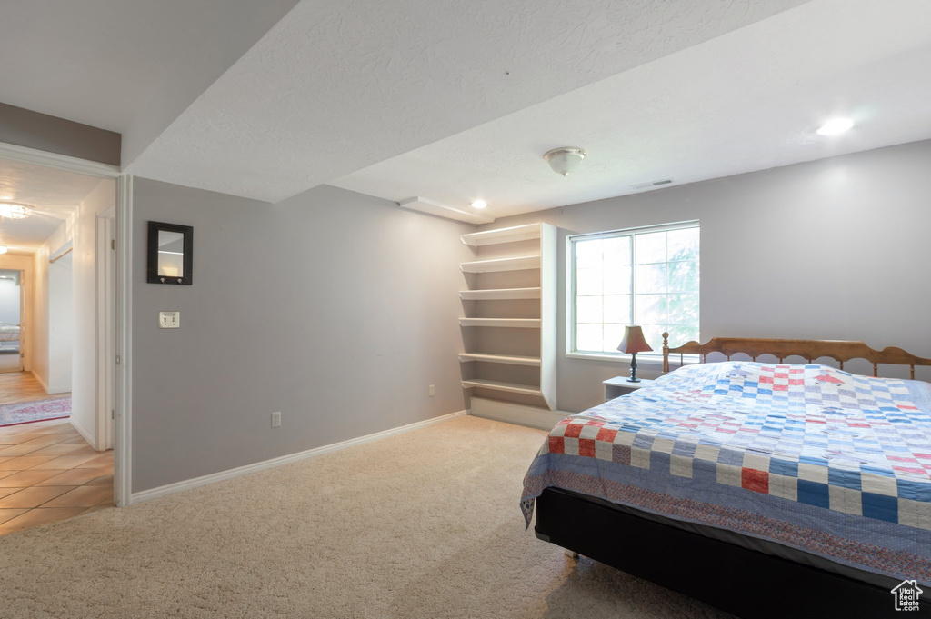 Carpeted bedroom with baseboards and recessed lighting
