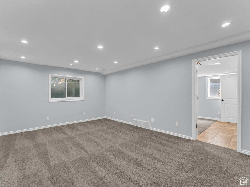 Empty room with carpet, recessed lighting, plenty of natural light, and baseboards