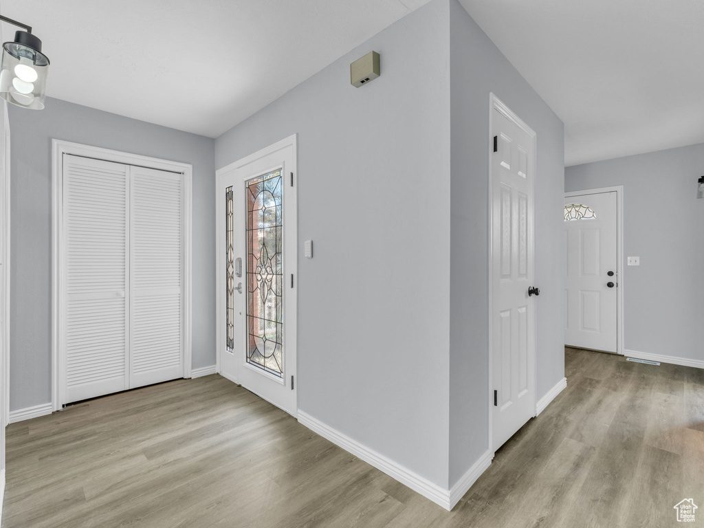 Foyer entrance featuring wood finished floors and baseboards