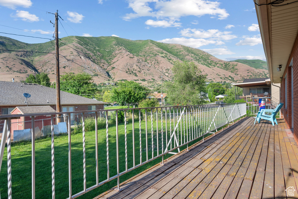 Wooden terrace with a mountain view and a yard