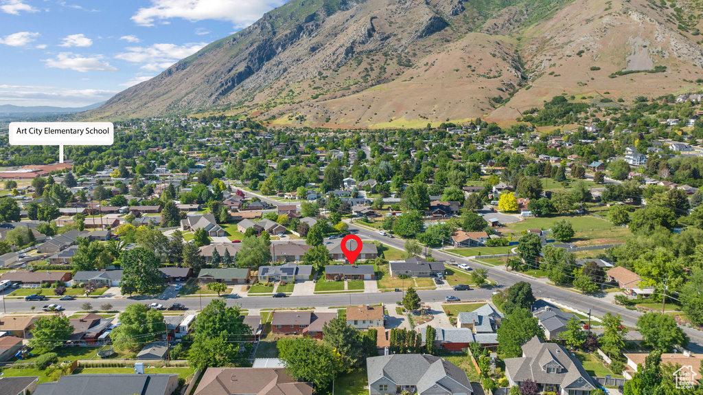 Aerial overview of property\\\'s location with a mountain backdrop and nearby suburban area