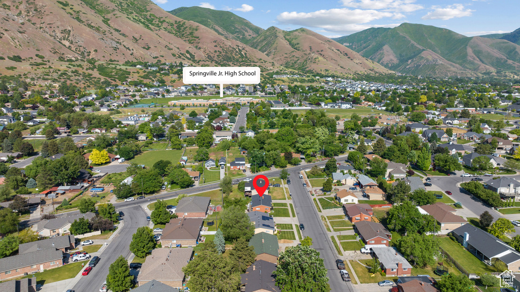 Aerial view of property\\\'s location with nearby suburban area and a mountainous background