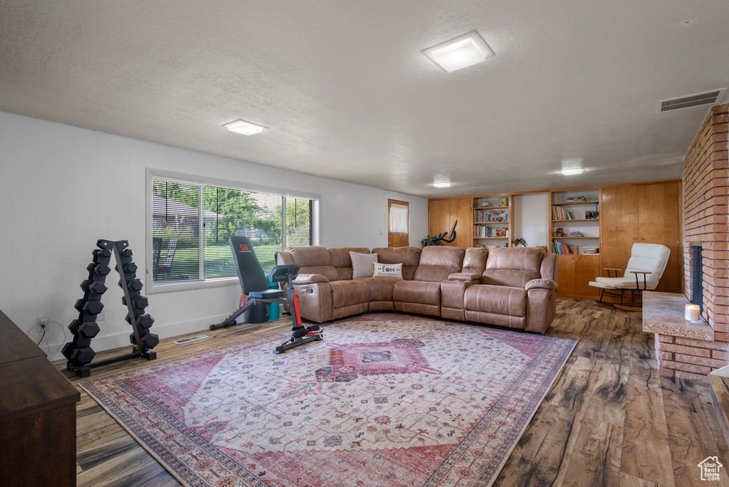 Living room featuring wood finished floors and a textured ceiling