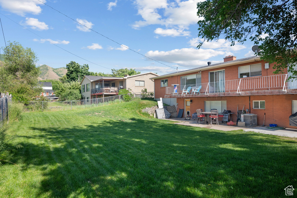 View of yard featuring a patio and central air condition unit