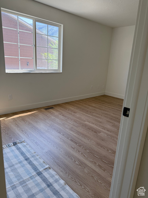 Spare room with wood finished floors and baseboards