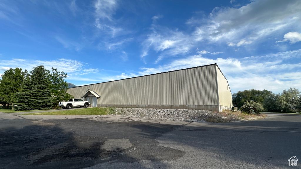 View of property exterior with an outbuilding and an outdoor structure