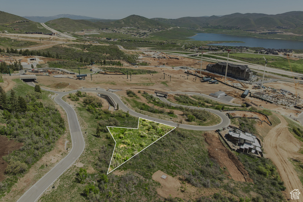 Aerial view of property and surrounding area featuring a water and mountain view and property boundaries highlighted