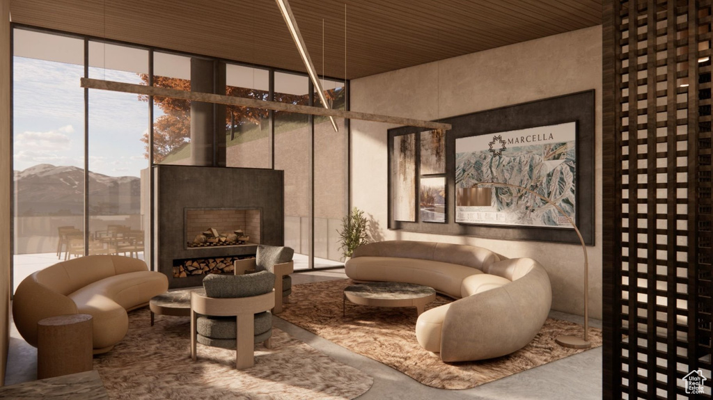 Lobby with a wall of windows, a mountain view, and wooden ceiling