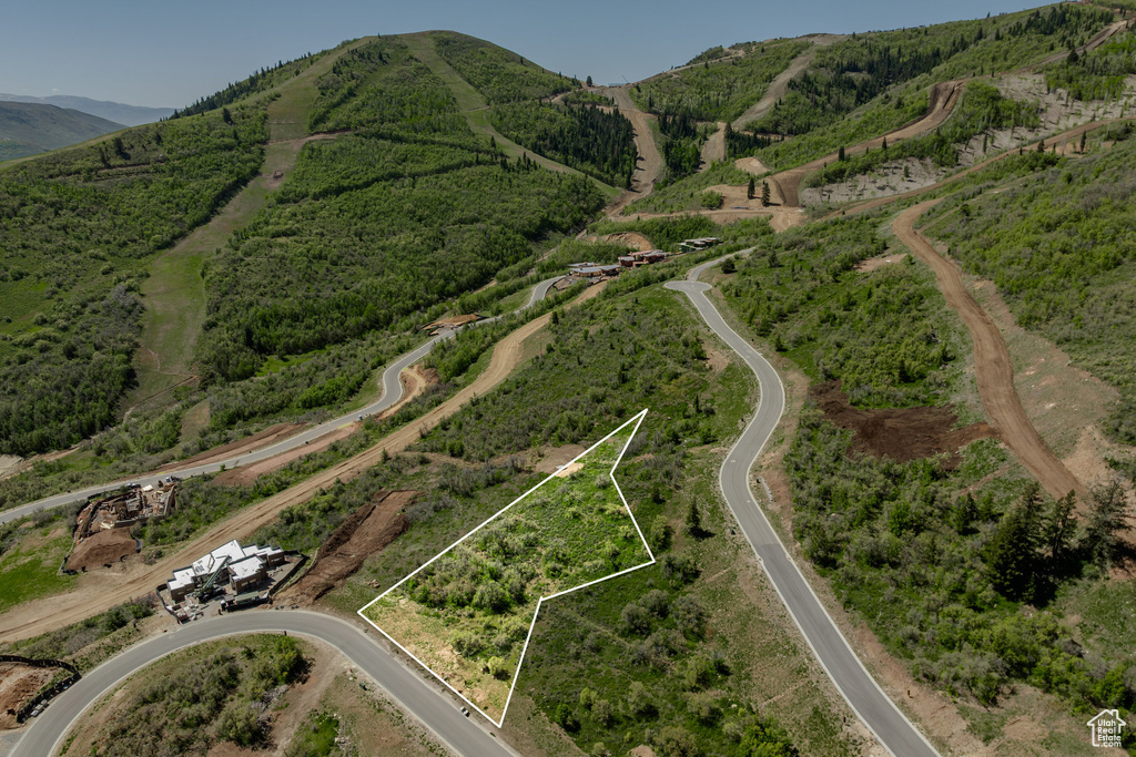 Aerial view of property\'s location with property parcel outlined and a mountainous background