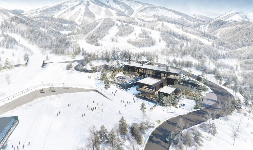 Snowy aerial view featuring a mountain view