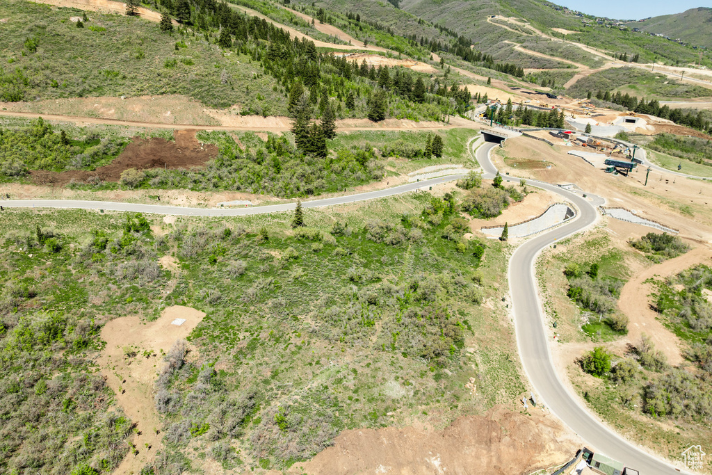 Aerial view of property\'s location featuring a mountainous background