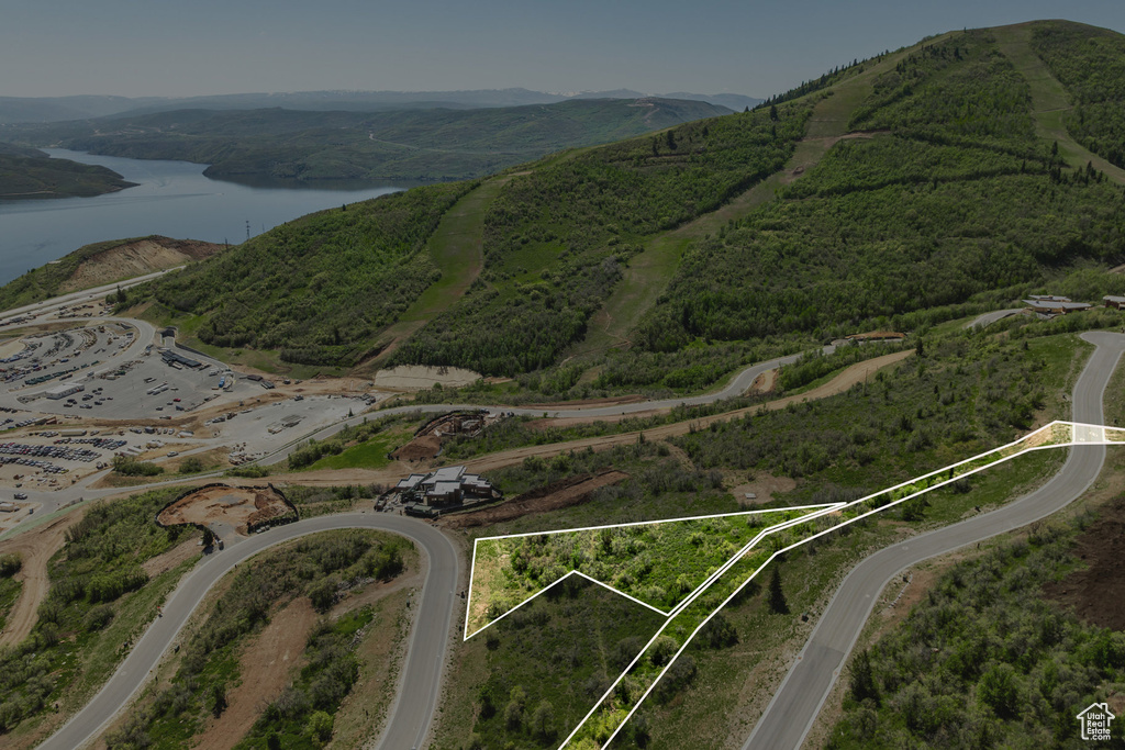 Aerial overview of property\'s location featuring a water and mountain view and property parcel outlined