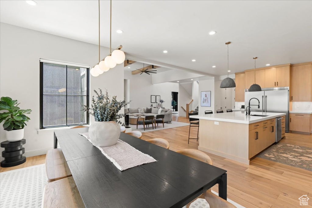 Dining room featuring stairway, light wood-style flooring, ceiling fan, and recessed lighting