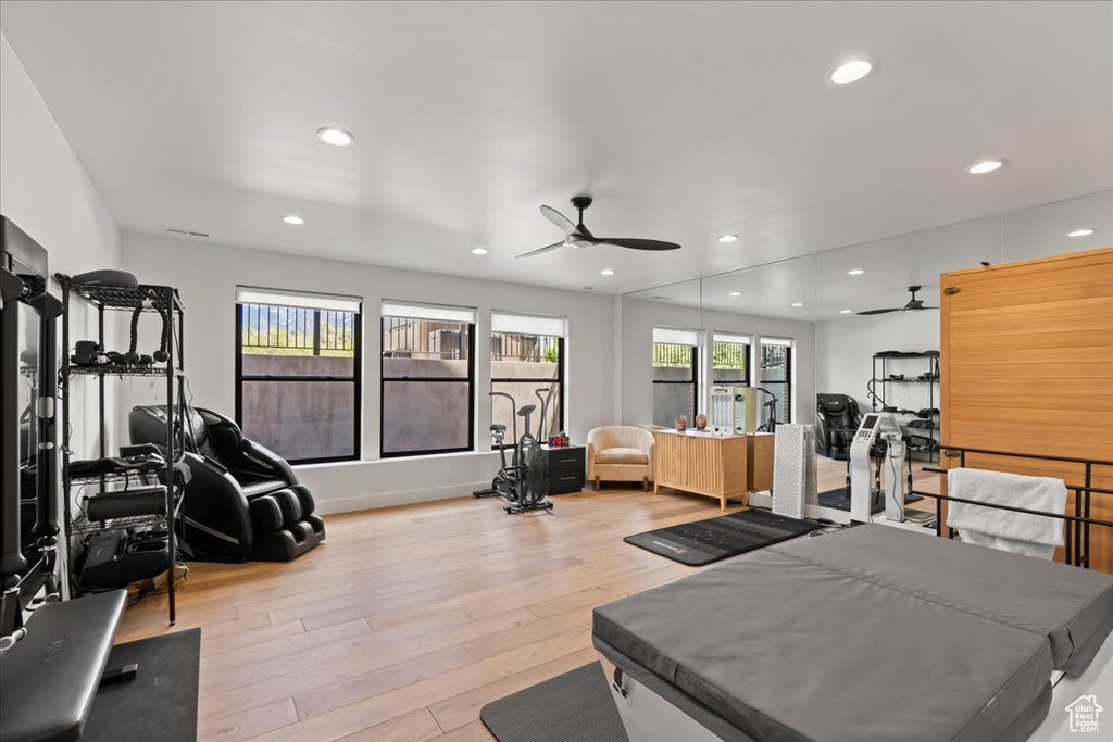 Workout room with a ceiling fan, wood finished floors, and recessed lighting