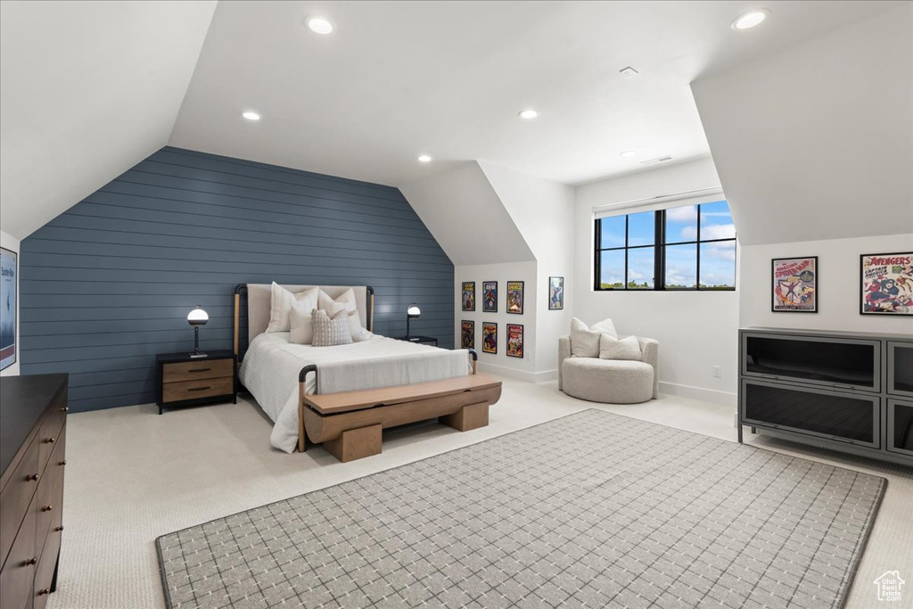 Carpeted bedroom with lofted ceiling, recessed lighting, wood walls, and baseboards