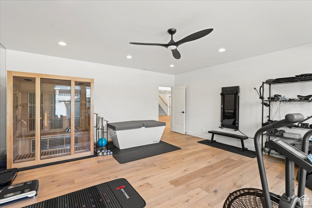 Exercise area with ceiling fan, wood finished floors, recessed lighting, and baseboards